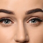 The Beginner's Guide to Filling In Thin Eyebrows (Without the Harsh Lines) Close-up of natural-looking filled eyebrows with defined arches and soft eye makeup.